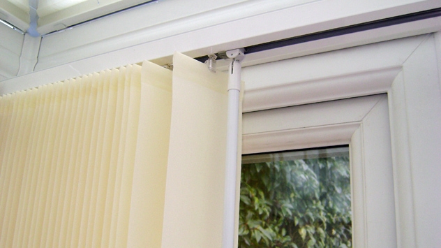 Close-up image of a vertical blind with operating wand
